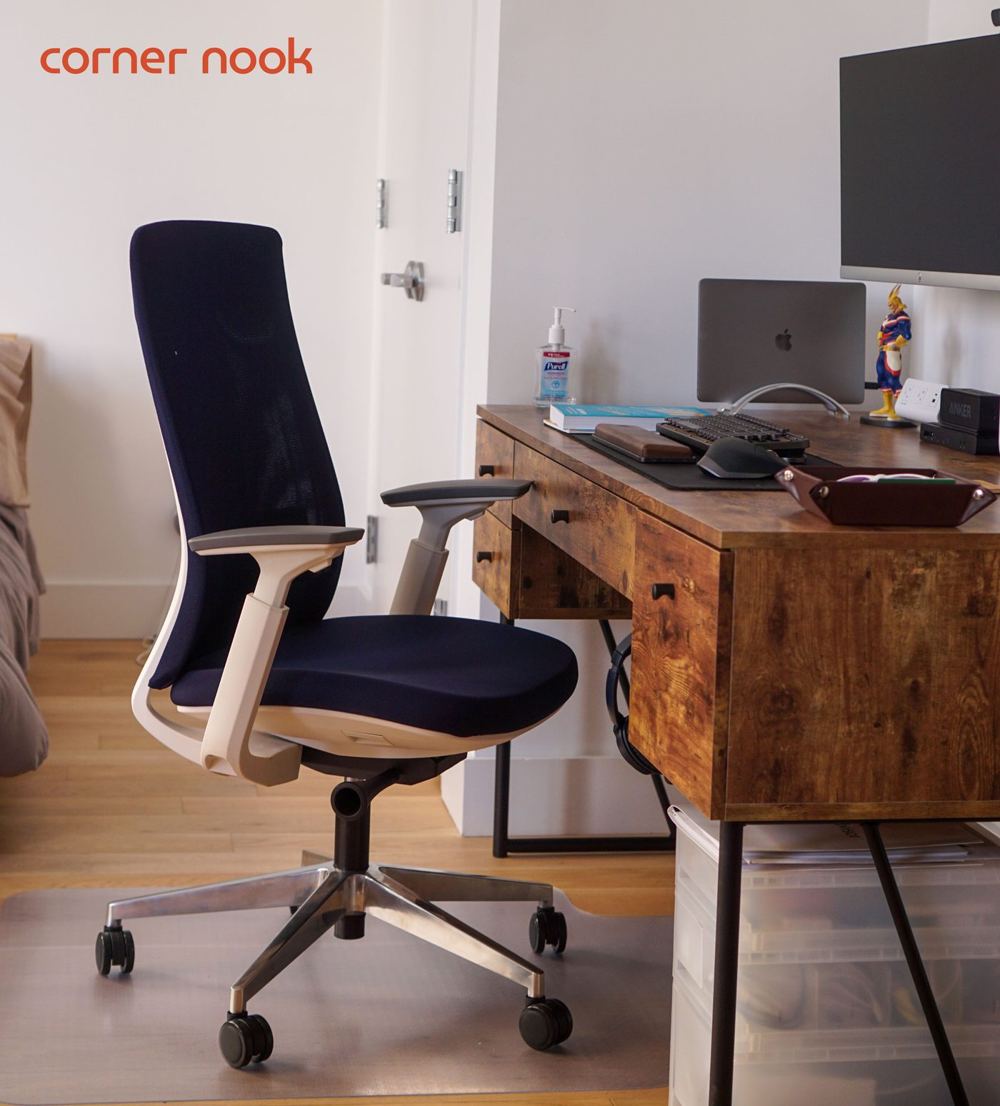 Eurotech Elevate task chair in navy with a white frame at a wooden corner desk