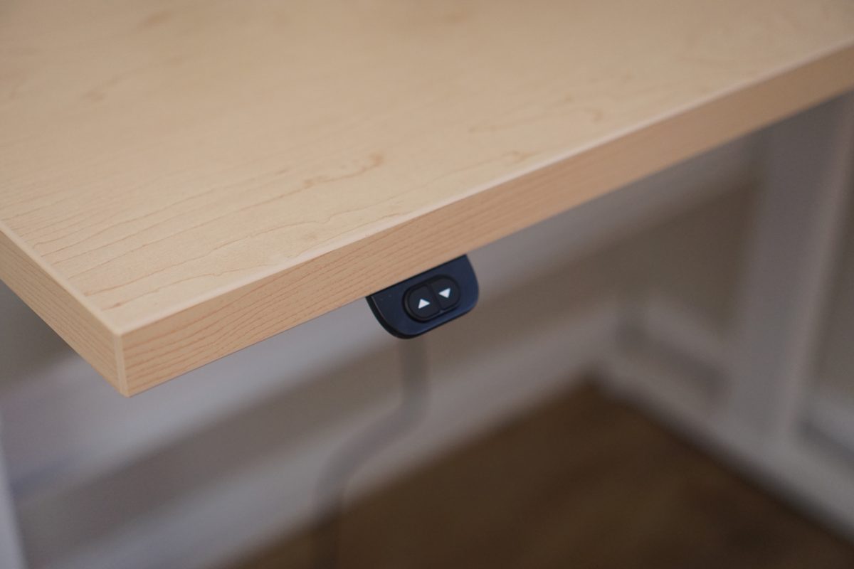 Close view of the two-button up and down switch mounted under the front edge of the Bonita ET's maple top
