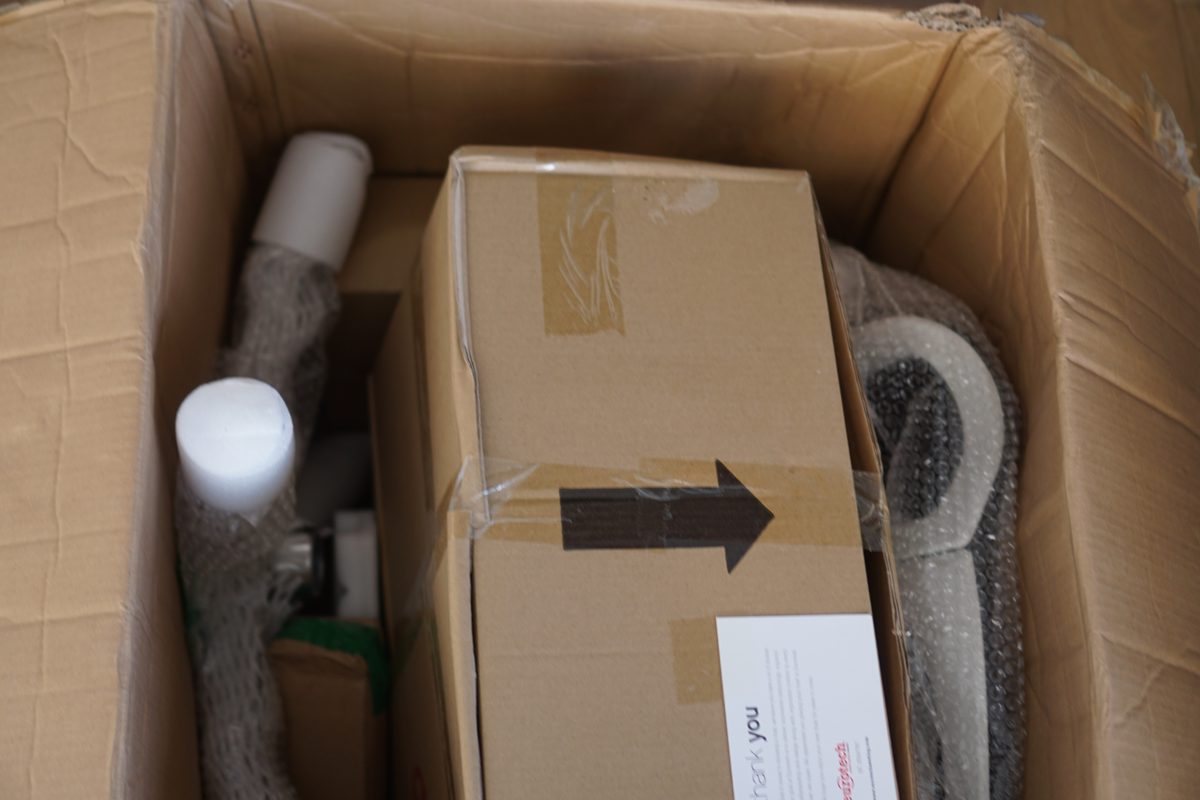 Inside the open Eurotech iOO box: smaller boxes and wrapped chair parts